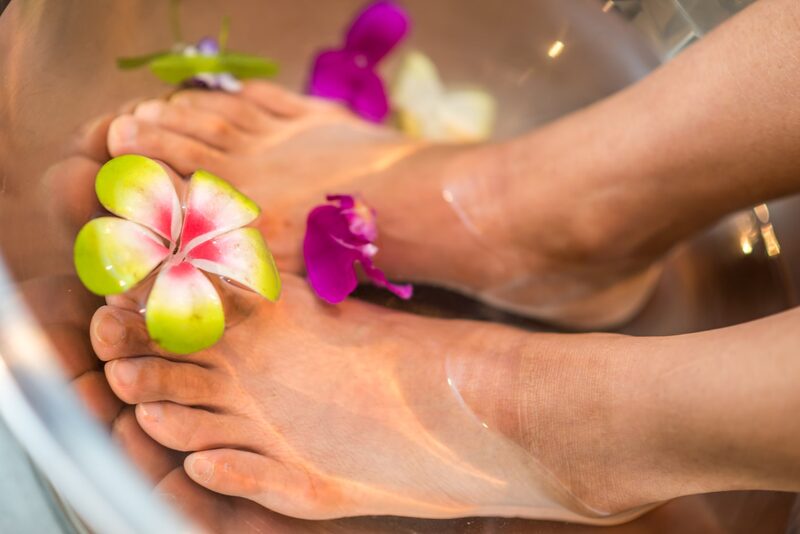 Feet adorned with flower petals during treatment